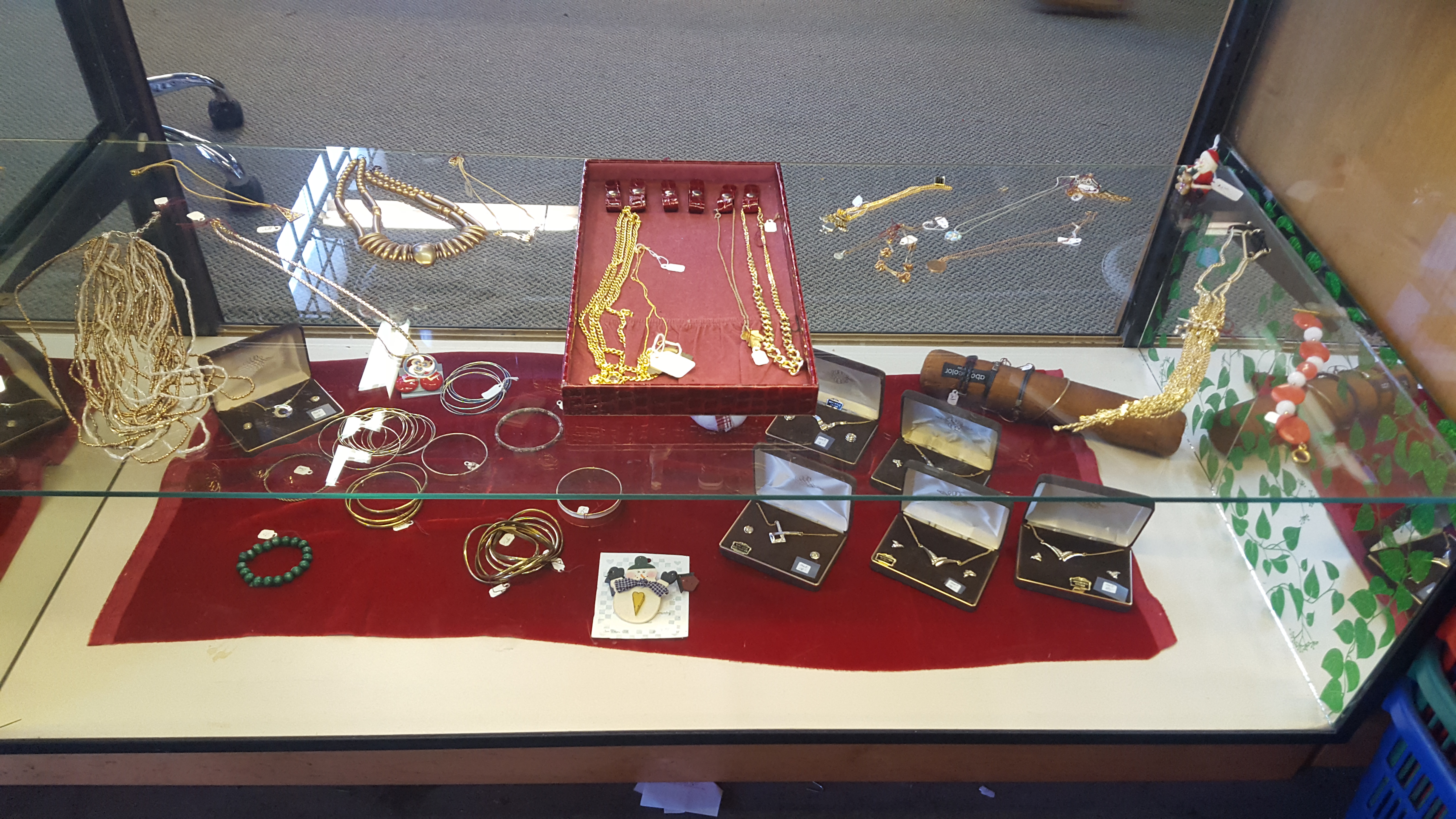 assortment of jewelry displayed on glass case