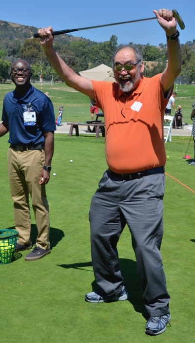 A golfer celebrates at the Pasadena Saving Strokes Golf Showcase.