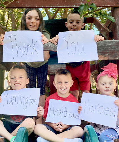 Five children holding signs that when read together say Thank you Huntington Healthcare heroes!