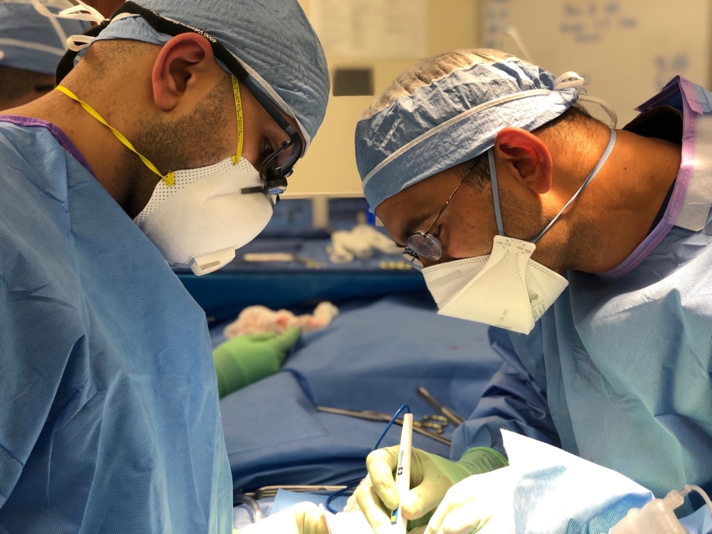 Two residents performing a simulated surgery