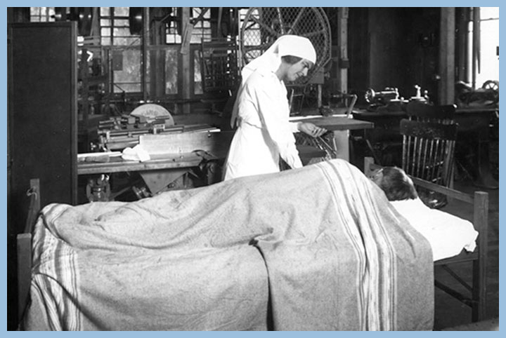 Black and white photo of patient in hospital bed with nurse