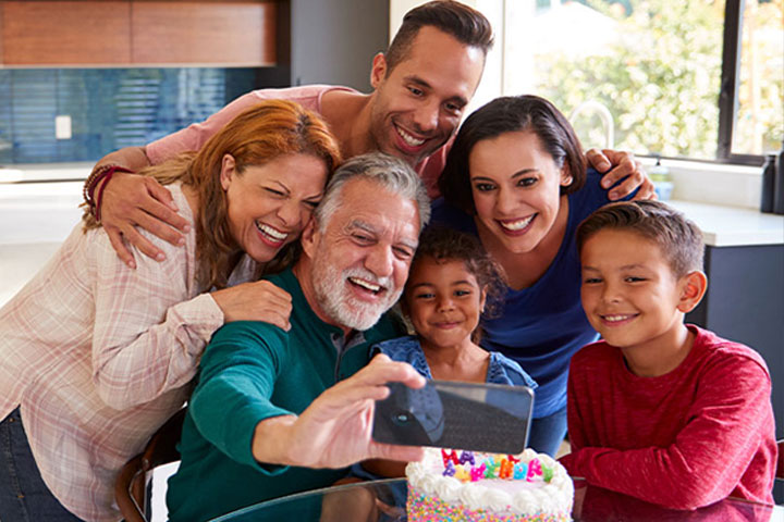 Multi-generational family smiling for selfie photo