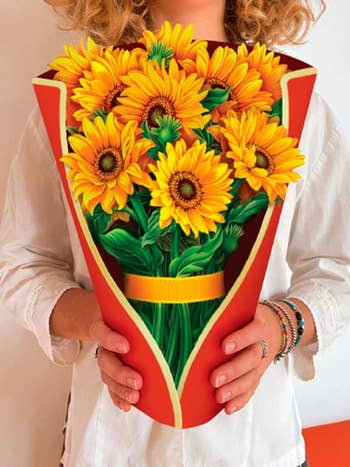 Woman holding an elaborate sunflower bunch shaped card