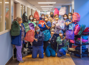 Huntington Health employees kick-off the school year with backpack donations to the community