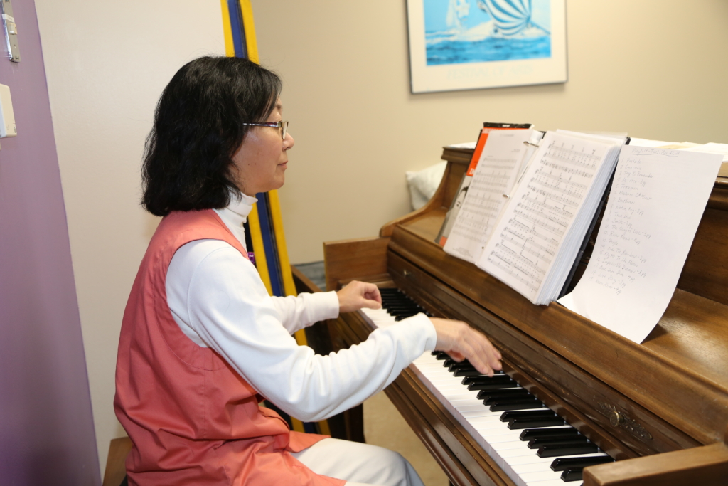 A music volunteer playing the piano.