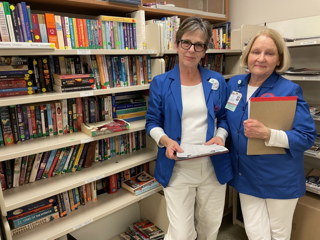 Two volunteers in the library