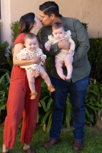 Patient story: Lemon Family - couple holding their twin babies and kissing