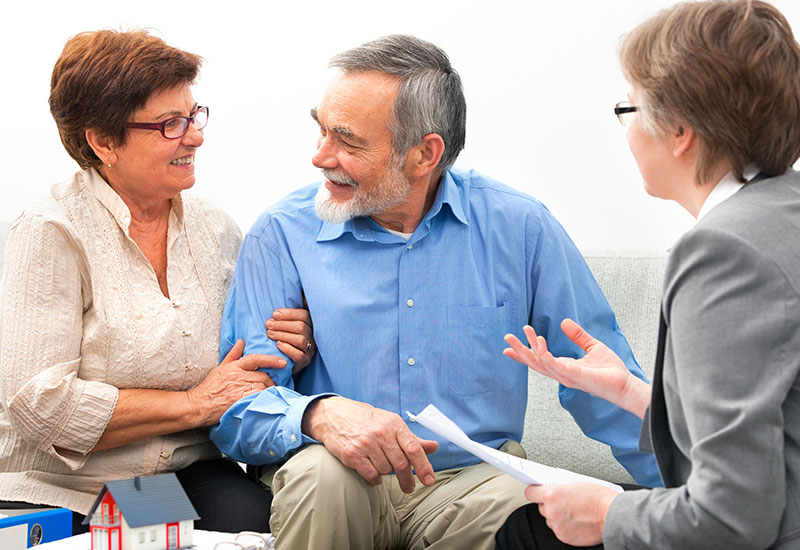 Advanced care planning: couple sitting and talking to an advisor
