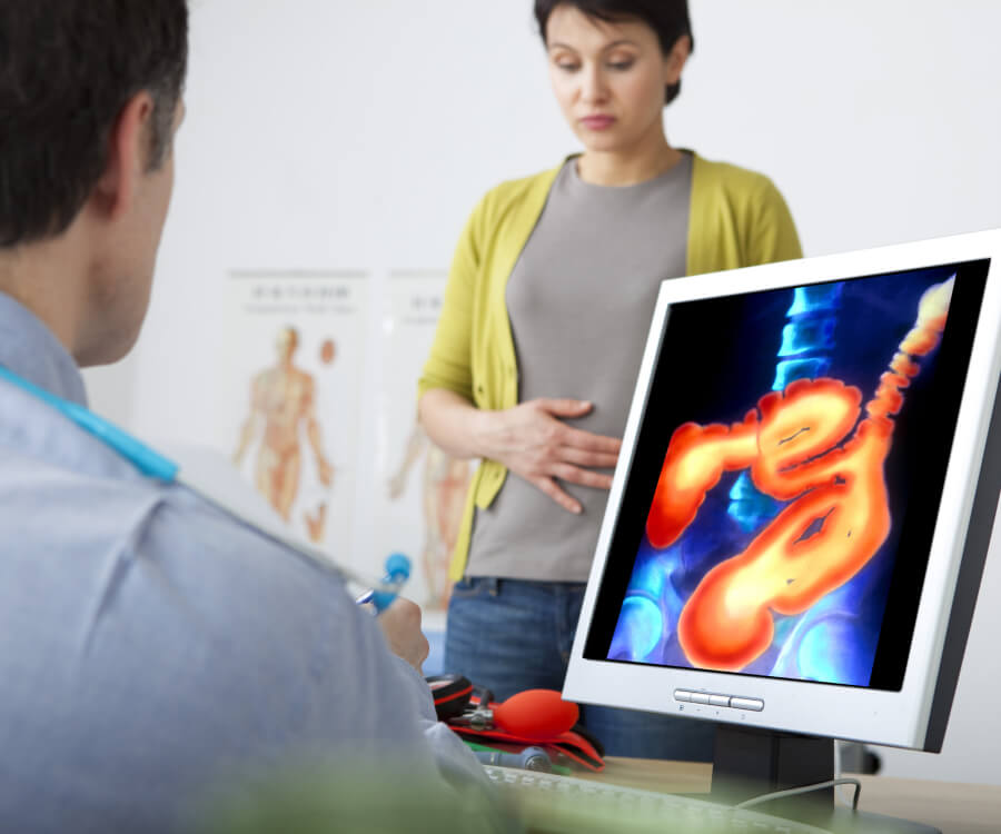 patient holder her stomach in pain at a doctor's office